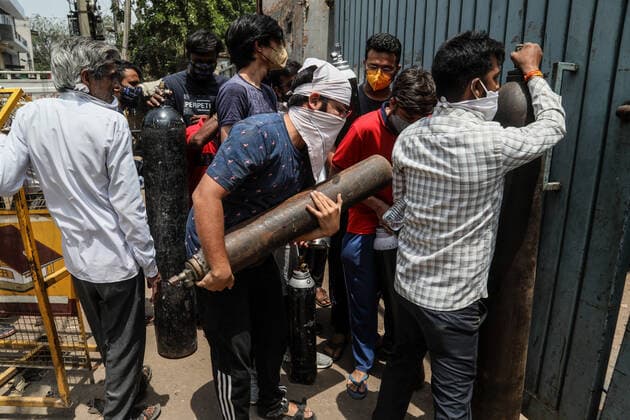 April 23, 2021, New Delhi, India: Family members of a Covid-19 infected patient stand in a queue while holding an empty oxygen cylinder outside the oxygen filling center in New Delhi..India is running out of oxygen during the second wave of Covid-19 pandemic. India has recorded 332,730 new Covid-19 cases in a single day and 2,263 deaths in the last one day. New Delhi India - ZUMAs197 20210423_zaa_s197_344 Copyright: xNaveenxSharmax