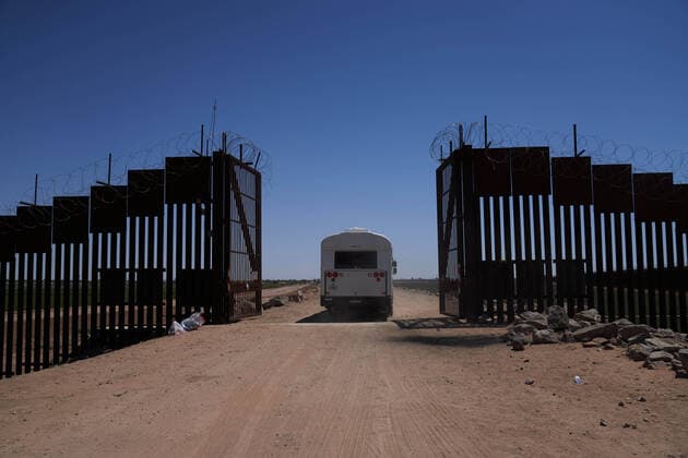 April 23, 2021, Yuma, Arizona, USA: A bus filled with asylum seeking migrants who surrendered to United States Border Patrol drives through the gate at the US Border Wall with Mexico in Yuma, AZ. Yuma USA - ZUMAd211 20210423_zap_d211_002 Copyright: xAllisonxDinnerx