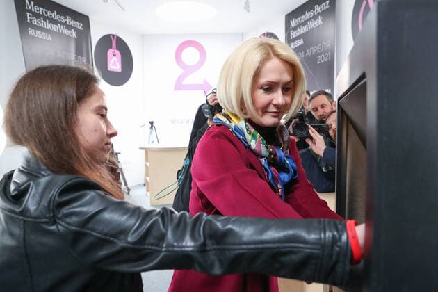 MOSCOW, RUSSIA â€“ APRIL 24, 2021: Russia s Deputy Prime Minister Viktoria Abramchenko (R) donates old clothes for recycling in the Museum of Moscow on the closing day of the 2021 Mercedes-Benz Fashion Week Russia. Sergei Karpukhin TASS  TS0FDEA6