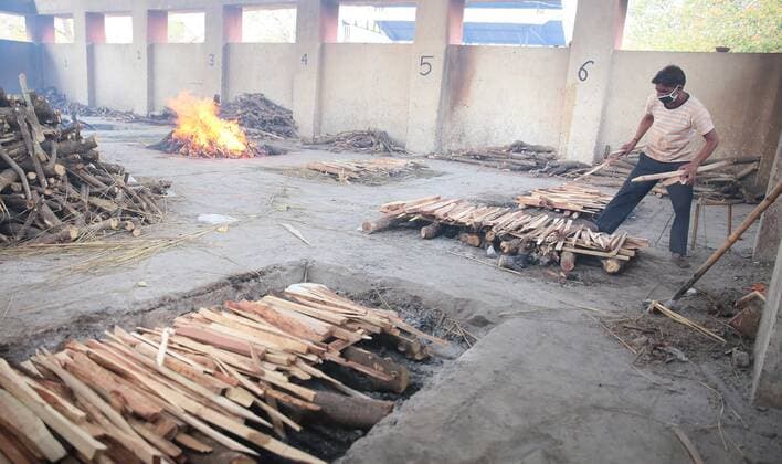 JAIPUR, INDIA - APRIl 23: A crematorium worker prepares new pyres for people who died of Covid-19, at Adarsh Nagar Cremation Ground, on April 23, 2021 in Jaipur, India. (Photo by Himanshu Vyas Hindustan Times) Covid Death Toll Continues To Rise In India