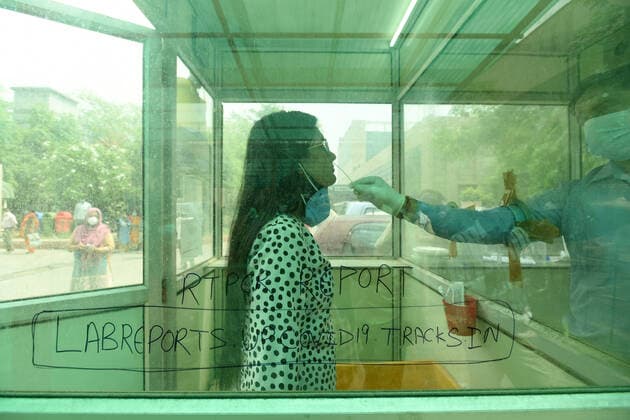 NOIDA, INDIA - APRIl 23: A health worker collects a swab sample for Covid-19 test, a district hospital at sector 30, on April 23, 2021 in Noida, India. (Photo by Sunil Ghosh Hindustan Times) Medical Team Conducts COVID-19 Coronavirus Test