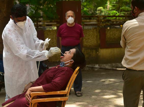 MUMBAI, INDIA - APRIl 23: A BMC medical staff collects a swab sample for COVID-19 test, at Dadar, on April 23, 2021 in Mumbai, India. (Photo by Anshuman Poyrekar Hindustan Times) Medical Team Conducts COVID-19 Coronavirus Test