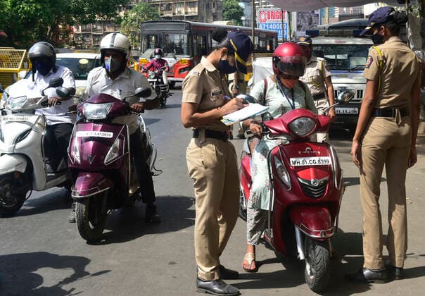 MUMBAI, INDIA - APRIl 23: Mumbai Police personnel check the vehicles at a police checkpost as only people in essential services are allowed to travel during the lockdown, at Prabhadevi, on April 23, 2021 in Mumbai, India. (Photo by Anshuman Poyrekar Hindustan Times) Daily Life Amid Coronavirus Pandemic In India