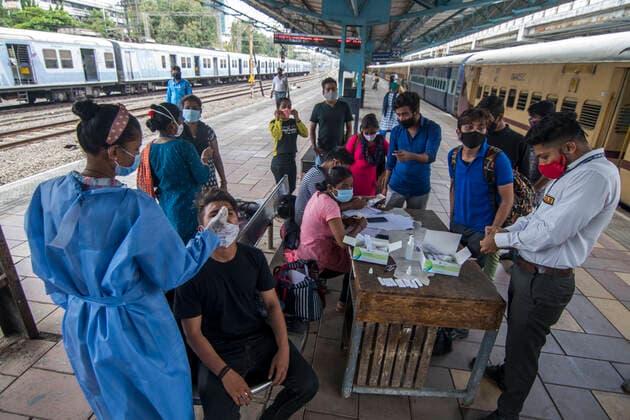 MUMBAI, INDIA - APRIl 23: Healthcare worker collects swab samples of passengers coming from outstation train at Dadar station, on April 23, 2021 in Mumbai, India. (Photo by Pratik Chorge Hindustan Times) Medical Team Conducts COVID-19 Coronavirus Test