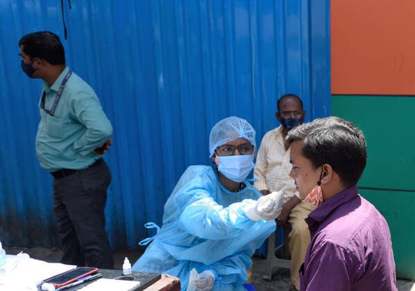 MUMBAI, INDIA - APRIl 23: A BMC healthcare worker collects a swab sample for COVId-19 test, at Andheri, on April 23, 2021 in Mumbai, India. (Photo by Satish Bate Hindustan Times) Medical Team Conducts COVID-19 Coronavirus Test