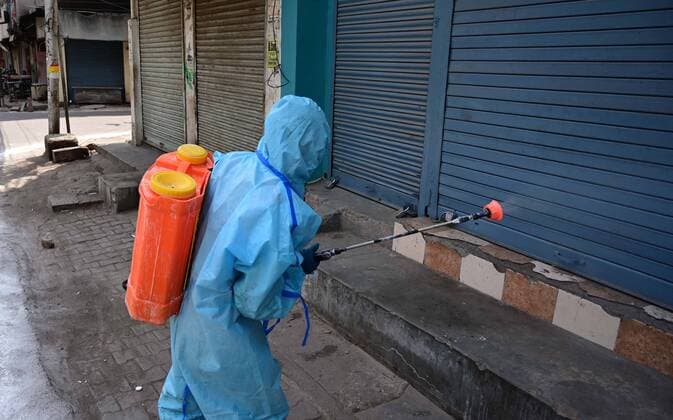 April 24, 2021, Prayagraj, Uttar Pradesh, India: Prayagraj: A municipal worker disinfecting closed shop at Chauwk area during a weekend lockdown imposed by the government as a preventive measure against the Covid-19 coronavirus, in Prayagraj on Saturday, April 24, 2021. Prayagraj India - ZUMAv115 20210424_zap_v115_003 Copyright: xPrabhatxKumarxVermax