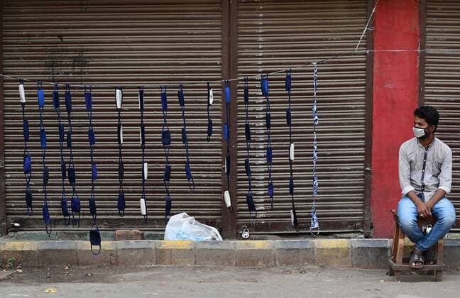 April 24, 2021, Prayagraj, Uttar Pradesh, India: Prayagraj: A roadside vendor sell mask in front of closed shop at Chauwk area during a weekend lockdown imposed by the government as a preventive measure against the Covid-19 coronavirus, in Prayagraj on Saturday, April 24, 2021. Prayagraj India - ZUMAv115 20210424_zap_v115_037 Copyright: xPrabhatxKumarxVermax