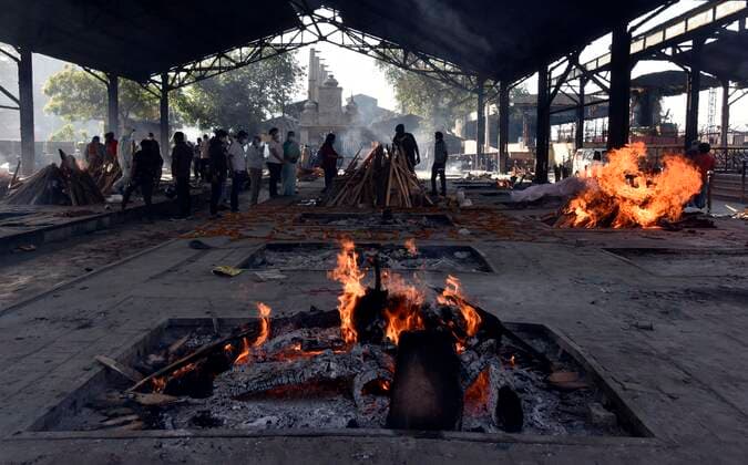 NEW DELHI, INDIA APRIL 24: A view of multiple funeral pyres of Covid-19 victims, at Nigambodh Ghat crematorium, on April 24, 2021 in New Delhi, India. (Photo by Sanjeev Verma Hindustan Times ) Covid Death Toll Continues To Rise In India