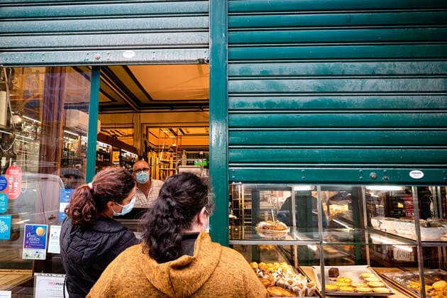 April 24, 2021, Porto, Portugal: A worker wearing a face mask serves two women at the entrance of his patisserie..Portugal is at the 3rd stage of the deconfinement plan but stores, restaurants and coffee shops are still closed on the weekend during the afternoon. Porto Portugal - ZUMAs197 20210424_zaa_s197_227 Copyright: xTeresaxNunesx