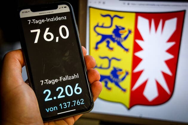 Coronavirus in Germany Covid 19 Dashboard of the Robert Koch Institute DEU, Germany, Schleswig Holstein, 25 04 2021 The 7-day incidence for the state Cases last 7 days 100 000 PE is displayed on an iPhone, with the state coat of arms in the background.