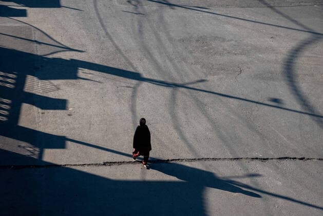 April 25, 2021, Srinagar, Jammu and Kashmir, India: A woman wearing a face mask walks along a deserted road during a one day curfew to curb the spread of COVID-19 in Srinagar..India has reported 346,786 new cases of COVID-19 for the previous 24 hours, with 2,624 deaths, the world™s highest daily toll since the pandemic begun last year. Overall, nearly 190,000 people have died from COVID in the country, while more than 16.6 million have been infected. Srinagar India - ZUMAs197 20210425_zaa_s197_062 Copyright: xIdreesxAbbasx