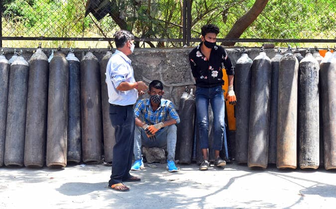NEW DELHI, INDIA APRIL 25: family member of Covid-19 infected patient carries an empty cylinder to refill outside the oxygen filling center at Dilshad Garden Area on April 25, 2021 in New Delhi, India. (Photo by Raj K Raj Hindustan Times ) Daily Life Amid Coronavirus Pandemic In India