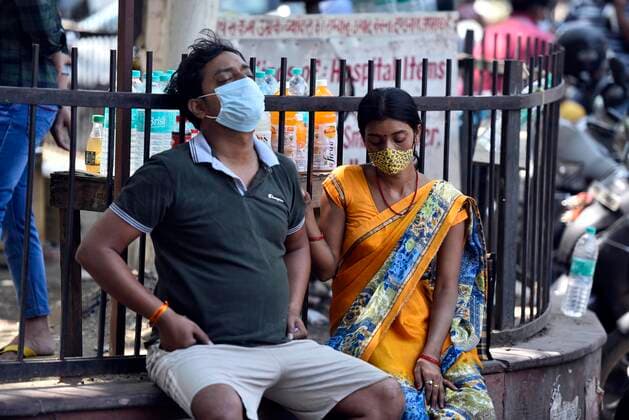 NEW DELHI, INDIA APRIL 25: A patients with his family members waiting outside the Covid-19 ward at Lok Nayak Jai Prakash (LNJP) hospital , on April 25, 2021 in New Delhi, India. (Photo by Sanjeev Verma Hindustan Times ) Daily Life Amid Coronavirus Pandemic In India