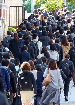 April 26, 2021, Tokyo, Japan - People walk to their offices amid outbreak of the new coronavirus in Tokyo on Monday, April 26, 2021. Tokyo, Osaka, Kyoto and Hyogo prefecture entered a new state of emergency for COVID-19 on April 25 through May 11.  (159071260)