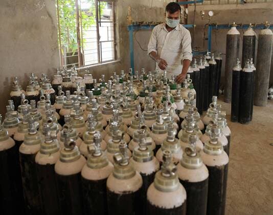 (210426) -- AGARTALA, April 26, 2021 -- A worker fills oxygen cylinders to supply to hospitals for COVID-19 patients in the outskirts of Agartala, the capital city of India s northeastern state of Tripura, April 26, 2021. (Str Xinhua) INDIA-AGARTALA-COVID-19-OXYGEN CYLINDER stringer 