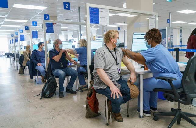 April 26, 2021, Montreal, PQ, Canada: Employees are vaccinated at a COVID-19 vaccination clinic at CAE headquarters in Montreal, on Monday, April 26, 2021. A provincial program to provide vaccinations at large businesses began today at the Montreal headquarters of the flight simulation technology manufacturer. Montreal Canada  - ZUMAc35_ 20210426_zaf_c35_051 Copyright: xPaulxChiassonx