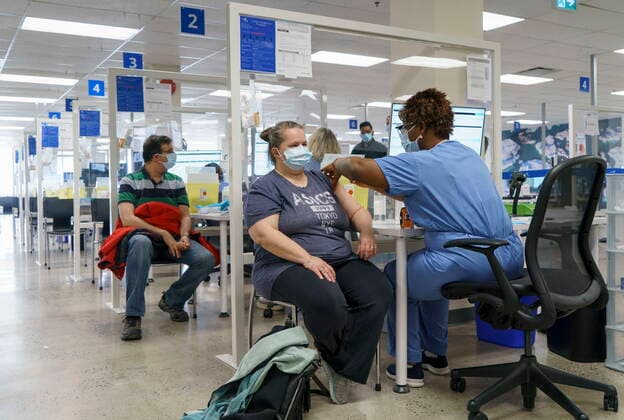 April 26, 2021, Montreal, PQ, Canada: Employees are vaccinated at a COVID-19 vaccination clinic at CAE headquarters in Montreal, on Monday, April 26, 2021. A provincial program to provide vaccinations at large businesses began today at the Montreal headquarters of the flight simulation technology manufacturer. Montreal Canada  - ZUMAc35_ 20210426_zaf_c35_053 Copyright: xPaulxChiassonx