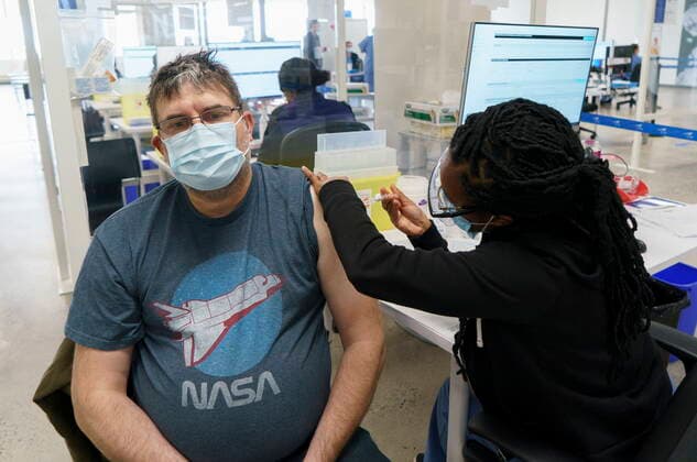 April 26, 2021, Montreal, PQ, Canada: An employee is vaccinated at a COVID-19 vaccination clinic at CAE headquarters in Montreal, on Monday, April 26, 2021. A provincial program to provide vaccinations at large businesses began today at the Montreal headquarters of the flight simulation technology manufacturer. Montreal Canada  - ZUMAc35_ 20210426_zaf_c35_056 Copyright: xPaulxChiassonx