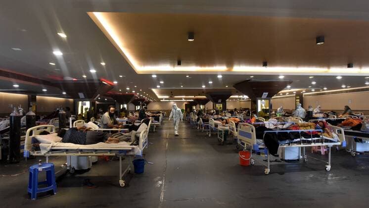 NEW DELHI, INDIA - APRIL 26: Patients rest at the Covid-19 Care Centre, for a temporary Covid Care Centre set up at Shehnai Banquet Hall attached to LNJP Hospital, on April 26, 2021 in New Delhi, India. India has registered 2,762 new deaths and 319,315 new infections recording more than 300,000 daily Covid-19 cases for the fifth day in a row, reaching a new record peak. (Photo by Sonu Mehta Hindustan Times) Temporary Covid-19 Care Centre In Delhi