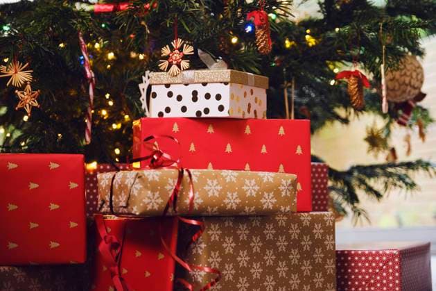 Stack of gifts in front of Christmas tree at home property released PWF00280