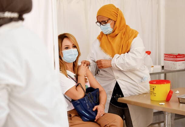April 27, 2021, Tunis, Tunisia: A woman receives a dose of the Pfizer-BioNTech COVID-19 vaccine at Ariana Youth Center as vaccination centers across the country experience an influx of registrations during Ramadan. Tunis Tunisia - ZUMAs197 20210427_zaa_s197_026 Copyright: xJdidixWassimx