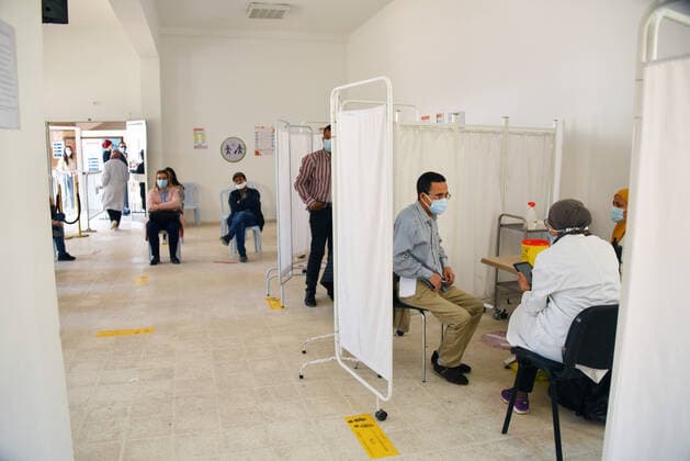 April 27, 2021, Tunis, Tunisia: People wait to receive a dose of the Pfizer-BioNTech COVID-19 vaccine at Ariana Youth Center as vaccination centers across the country experience an influx of registrations during Ramadan. Tunis Tunisia - ZUMAs197 20210427_zaa_s197_030 Copyright: xJdidixWassimx