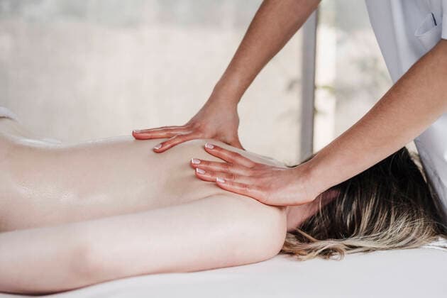 Female therapist massaging patient in clinic model released Symbolfoto property released EBBF03279