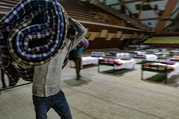 COVID-19: Jammu and Kashmir records 3,164 new cases, 25 deaths SRINAGAR, INDIA, 27 APRIL 2021 - Workers prepare beds at a new makeshift Covid-19 quarantine facility with the capacity of 111 beds inside the Indoor Sports Stadium in Srianagar. After Jammu and Kashmir recorded its highest single-day spike of 3,164 COVID-19 cases, which took the tally to 166,054, while 25 fatalities over the last 24 hours took the toll to 2,197, officials said. SRINAGAR Jammu And Kashmir India Copyright: AdilxAbass