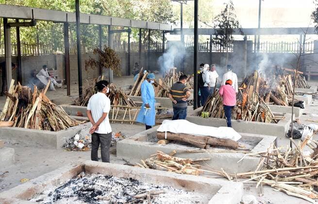 NEW DELHI, INDIA - APRIL 27: funeral pyres lit to cremate covid-19 victims at Sarai Kale Khan crematorium on April 27, 2021 in New Delhi, India. India has registered 2,762 new deaths and 319,315 new infections recording more than 300,000 daily Covid-19 cases for the fifth day in a row, reaching a new record peak. (Photo by Sonu Mehta Hindustan Times) Covid Death Toll Continues To Rise In India