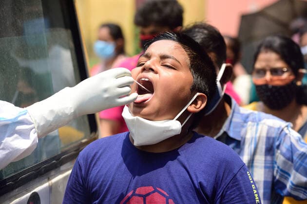 April 28, 2021, Kolkata, West Bengal, India: A healthcare worker collects swab samples from a kid for RTPCR covid 19 tests..There has been a scarcity of hospital beds reported in Kolkata as well as other Indian states along with medical oxygen. Kolkata India - ZUMAs197 20210428_zaa_s197_013 Copyright: xSumitxSanyalx
