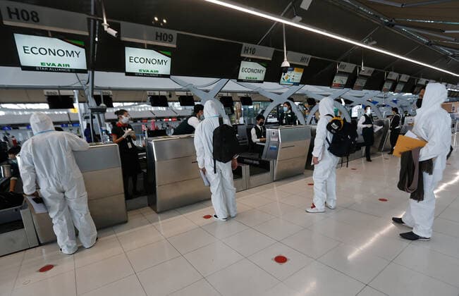 April 28, 2021, Bangkok, Thailand: Passengers wearing personal protective equipment suite (PPE) check-in at EVA Air row at Suvarnabhumi airport..Ministry of Public Health and the Airport Operation Centre set up a new vaccination centre to remedy the Covid 19 emergency situation and efficiency of vaccination for aviation-related personnel. Bangkok Thailand - ZUMAs197 20210428_zaa_s197_031 Copyright: xChaiwatxSubprasomx