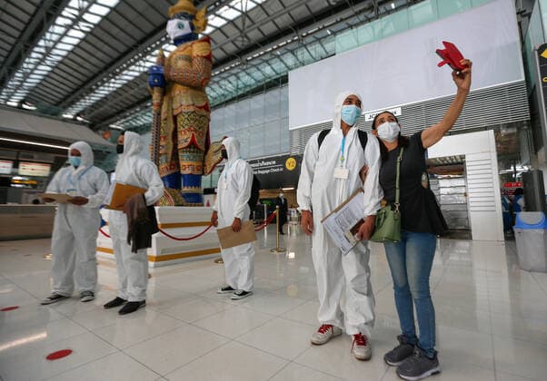 April 28, 2021, Bangkok, Thailand: A passenger wearing personal protective equipment suite (PPE) takes a selfie with his mother at Suvarnabhumi airport..Ministry of Public Health and the Airport Operation Centre set up a new vaccination centre to remedy the Covid 19 emergency situation and efficiency of vaccination for aviation-related personnel. Bangkok Thailand - ZUMAs197 20210428_zaa_s197_034 Copyright: xChaiwatxSubprasomx