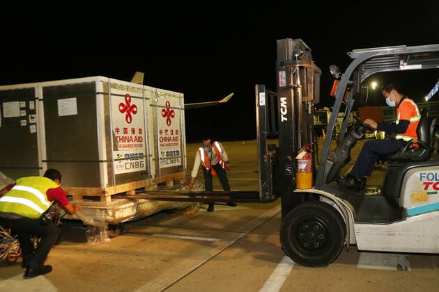(210429) -- PHNOM PENH, April 29, 2021 -- Workers transport Sinopharm COVID-19 vaccine at the Phnom Penh International Airport in Phnom Penh, Cambodia, April 28, 2021. A plane carrying the third batch of China-donated Sinopharm COVID-19 vaccine arrived in the capital of Cambodia Wednesday night. (Photo by Xinhua) COMBIDIA-PHNOM PENH-COVID-19-CHINESE VACCINE-ARRIVAL LyxLay 