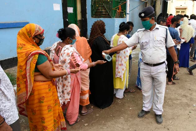 India: 8th Phase of Polling at West Bengal Kolkata Police spray hand sanitizer before enter the Polling Booth. Kolkata India Copyright: SuraranjanxNandi