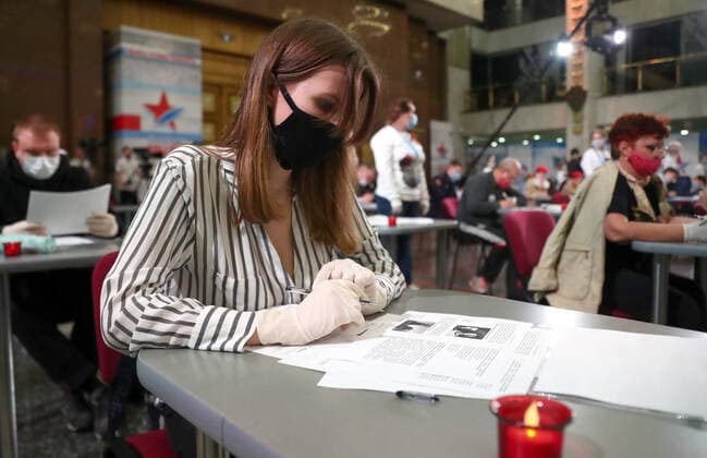 MOSCOW, RUSSIA â€“ APRIL 29, 2021: A girl a face mask and protective gloves takes a history competence test on World War II, Victory Dictation, at the Victory Museum on Poklonnaya Hill. Mikhail Tereshchenko TASS  TS0FE745
