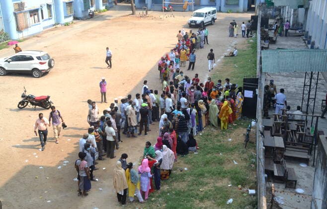 India: Last Phase of voting at West Bengal Assembly Election 2021 Voters are waiting to cast their EVM ballots. Many do not have a face mask and do not follow the distance Calcutta West Bengal India Copyright: AnubrataxMondal