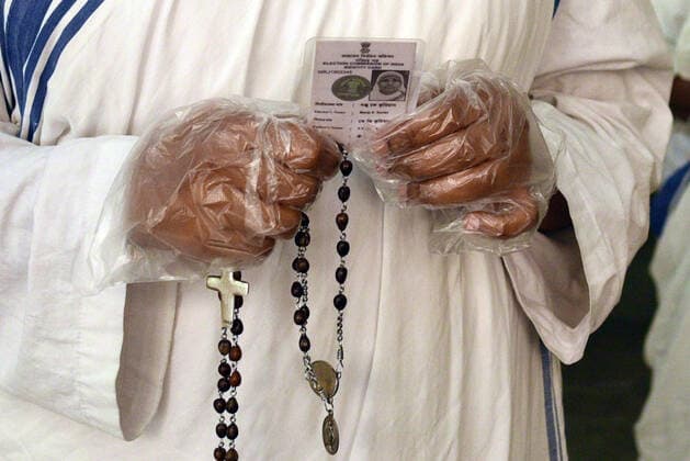 KOLKATA, INDIA - APRIL 29: A nun of Missionaries of Charity holding a rosary and a voter id card while in a queue to cast vote during the eighth phase of West Bengal Assembly Electionss, at St. Mary s School on April 29, 2021 in Kolkata, India. Sealing the fate of West Bengal, the last of the 8-phase state elections is currently underway with 35 seats up for grabs. Results for all 294 seats will be announced on May 2. (Photo by Samir Jana Hindustan Times) Voting For Eight Phase Of West Bengal Assembly Elections