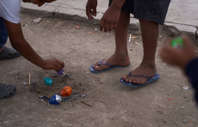 April 29, 2021, Reynosa, Mexico: Central American children play with toys on the street. Asylum seeking migrants from Central America are living on the street in Reynosa, Mexico while they wait for President Joe Biden to open the US border for them to try to cross. Reynosa Mexico - ZUMAd211 20210429_zap_d211_001 Copyright: xAllisonxDinnerx