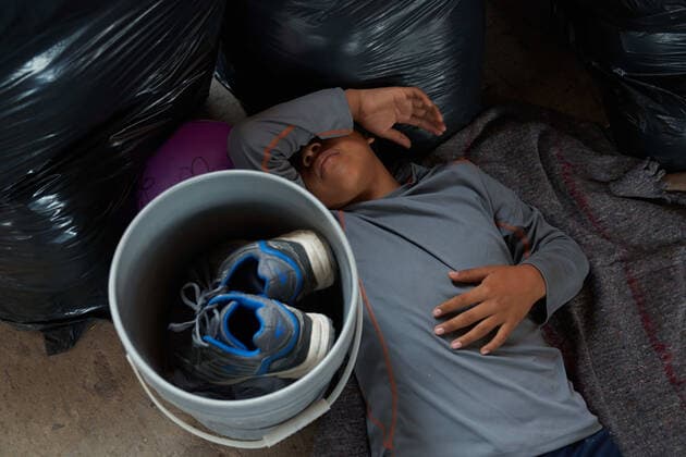 April 29, 2021, Reynosa, Mexico: A child sleeps on the cement floor. Asylum seeking migrants from Central America are living on the street in Reynosa, Mexico while they wait for President Joe Biden to open the US border for them to try to cross. Reynosa Mexico - ZUMAd211 20210429_zap_d211_016 Copyright: xAllisonxDinnerx