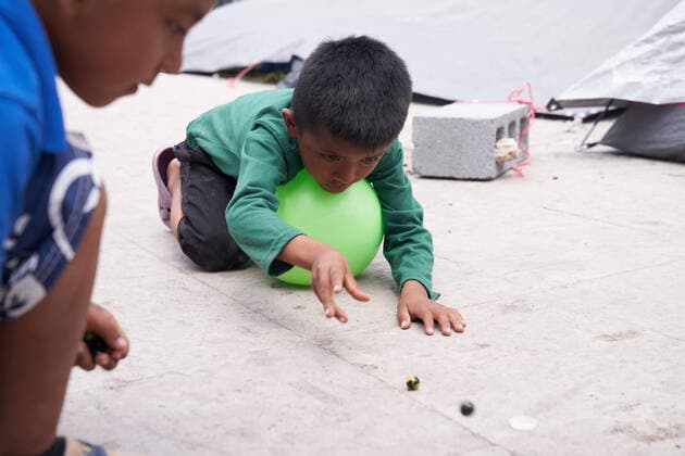April 29, 2021, Reynosa, Mexico: A child plays with marbles. Asylum seeking migrants from Central America are living on the street in Reynosa, Mexico while they wait for President Joe Biden to open the US border for them to try to cross. Reynosa Mexico - ZUMAd211 20210429_zap_d211_018 Copyright: xAllisonxDinnerx