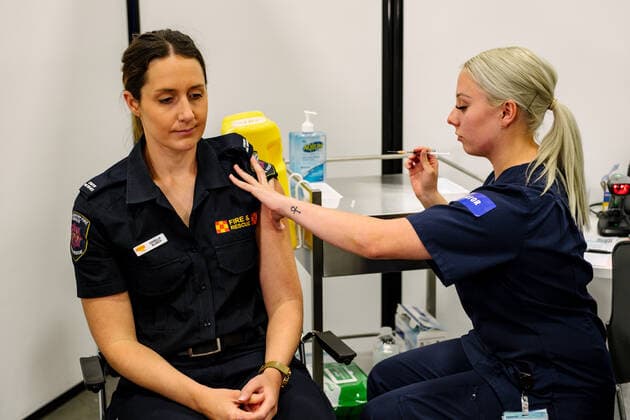 COVID19 VACCINATION ROLLOUT SA, Danielle Blanch of the CFS is vaccinated by RN Maddie Duggin at the Adelaide Showgrounds Vaccination Centre in Adelaide, Friday, April 30, 2021. ( NO ARCHIVING, EDITORIAL USE ONLY, NO USE IN BOOKS WITHOUT CONSENT ADELAIDE SA AUSTRALIA  Copyright: xMORGANxSETTEx 20210430001538622623