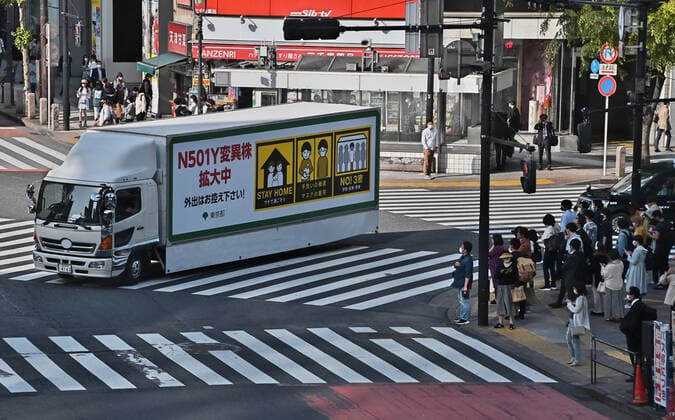 A truck with a COVID-19 awareness advertisement is seen runs at Shibuya crossing in Tokyo, Japan on Friday, April 30, 2021. Tokyo, Osaka, Kyoto and Hyogo prefectures entered a new state of emergency for COVID-19 on April 25 through May 11.  TKP2021043013 KEIZOxMORI