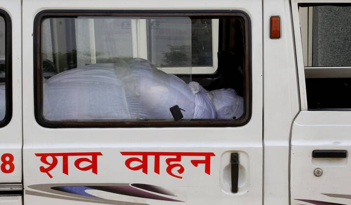 April 30, 2021, New Delhi, India: (EDITORS NOTE: Image depicts death).A body of coronavirus Covid-19 victim lies inside the hearse for the mass cremation at Dwarka crematorium..The ongoing vaccination drive will open for 18-45 age group from May 01, 2021. India has recorded 386,452 new coronavirus infection cases and 3,498 death in the last 24 hours. New Delhi India - ZUMAs197 20210430_zaa_s197_069 Copyright: xNaveenxSharmax