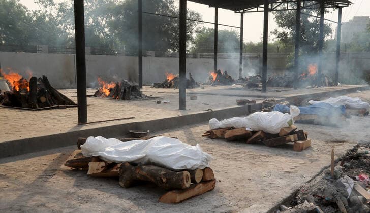 April 30, 2021, New Delhi, India: (EDITORS NOTE: Image depicts death).Bodies of those who lost their life due to the coronavirus Covid-19 disease wait to be cremated during the mass cremation at Dwarka crematorium..The ongoing vaccination drive will open for 18-45 age group from May 01, 2021. India has recorded 386,452 new coronavirus infection cases and 3,498 death in the last 24 hours. New Delhi India - ZUMAs197 20210430_zaa_s197_073 Copyright: xNaveenxSharmax