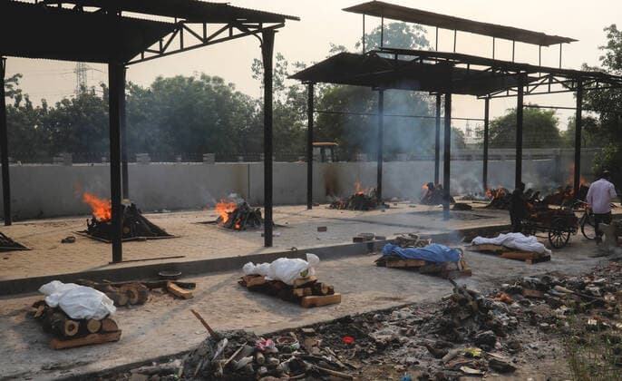 April 30, 2021, New Delhi, India: (EDITORS NOTE: Image depicts death).Bodies of those who lost their life due to the coronavirus Covid-19 disease wait to be cremated during the mass cremation at Dwarka crematorium..The ongoing vaccination drive will open for 18-45 age group from May 01, 2021. India has recorded 386,452 new coronavirus infection cases and 3,498 death in the last 24 hours. New Delhi India - ZUMAs197 20210430_zaa_s197_075 Copyright: xNaveenxSharmax