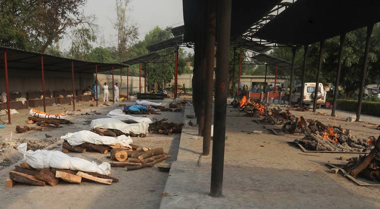 April 30, 2021, New Delhi, India: (EDITORS NOTE: Image depicts death).Bodies of those who lost their life due to the coronavirus Covid-19 disease wait to be cremated during the mass cremation at Dwarka crematorium..The ongoing vaccination drive will open for 18-45 age group from May 01, 2021. India has recorded 386,452 new coronavirus infection cases and 3,498 death in the last 24 hours. New Delhi India - ZUMAs197 20210430_zaa_s197_079 Copyright: xNaveenxSharmax