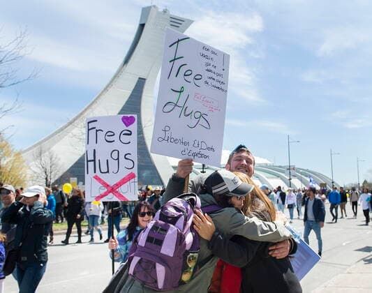 May 1, 2021, Montreal, PQ, Canada: People hug as they take part in a demonstration opposing the Quebec governmentÃ¢â‚¬â ¢s health measures to help curb the spread of COVID-19 in Montreal, Saturday, May 1, 2021. Montreal Canada  - ZUMAc35_ 20210501_zaf_c35_047 Copyright: xGrahamxHughesx