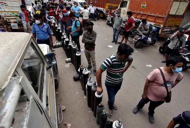 NEW DELHI, INDIA - MAY 2: People wait to refill empty oxygen cylinders, at Bhogal Jangpura, on May 2, 2021 in New Delhi, India. (Photo by Sanjeev Verma Hindustan Times ) Daily Life Amid Coronavirus Pandemic In India