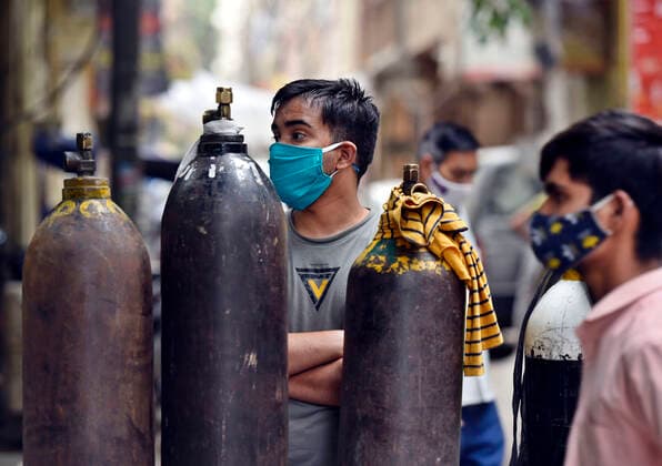 NEW DELHI, INDIA - MAY 2: A rush of people waiting to refill empty oxygen cylinders, at Bhogal Jangpura, on May 2, 2021 in New Delhi, India. (Photo by Sanjeev Verma Hindustan Times ) Daily Life Amid Coronavirus Pandemic In India