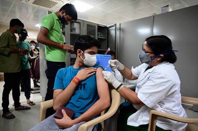 May 3, 2021, Prayagraj, Uttar Pradesh, India: Prayagraj: A medical worker inoculates a youth with a dose of the Covishield coronavirus vaccine, at Moti Lal Nehru Medical College in Allahabad on Monday, May 03, 2021 during the first day of India s vaccination drive to all adults. Prayagraj India - ZUMAv115 20210503_zap_v115_010 Copyright: xPrabhatxKumarxVermax